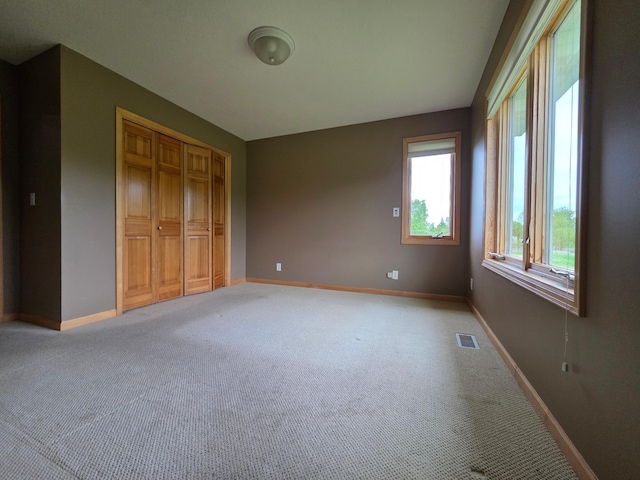 7390 360th St, North Branch, MN 55056 - unfurnished bedroom with light colored carpet, baseboards, and a closet
