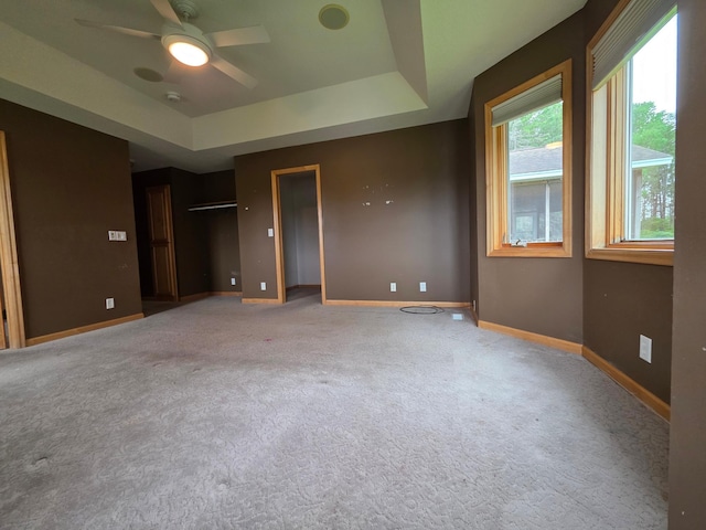7390 360th St, North Branch, MN 55056 - unfurnished bedroom featuring baseboards, carpet flooring, a tray ceiling, and ceiling fan