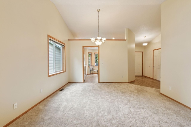 934 105th Ave NW, Coon Rapids, MN 55433 - unfurnished room featuring carpet flooring, baseboards, a chandelier, and vaulted ceiling
