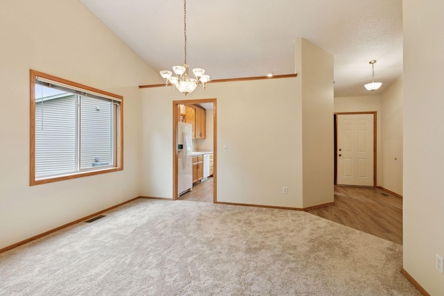 934 105th Ave NW, Coon Rapids, MN 55433 - empty room with light carpet, a chandelier, and baseboards