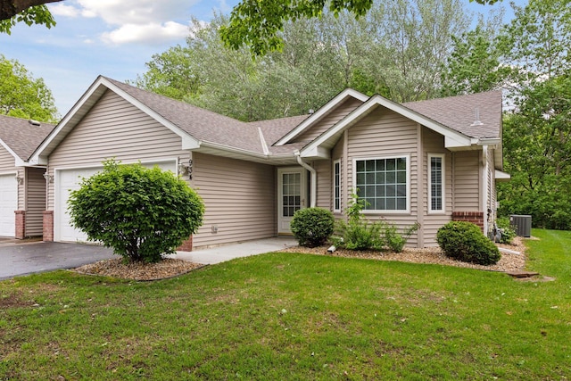 934 105th Ave NW, Coon Rapids, MN 55433 - ranch-style home featuring an attached garage, cooling unit, a shingled roof, a front lawn, and asphalt driveway