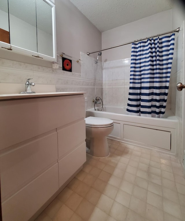 bathroom featuring shower / bath combo, toilet, a textured ceiling, tile walls, and vanity