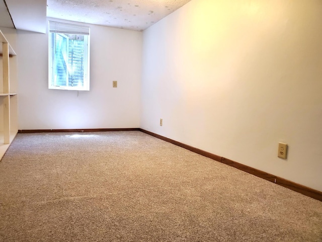 empty room with carpet and baseboards