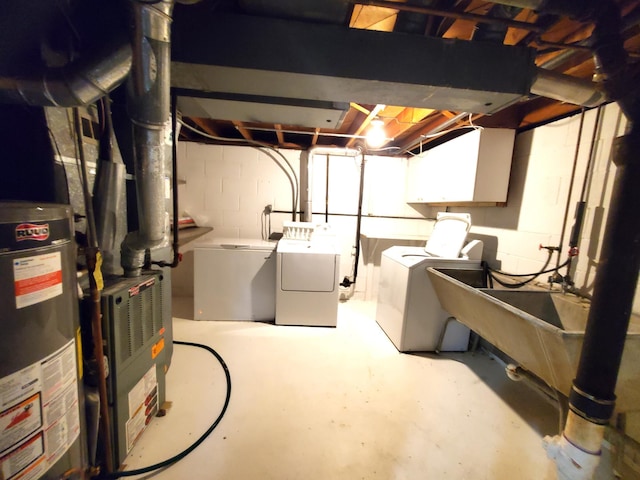 unfinished below grade area with washing machine and clothes dryer, gas water heater, and concrete block wall