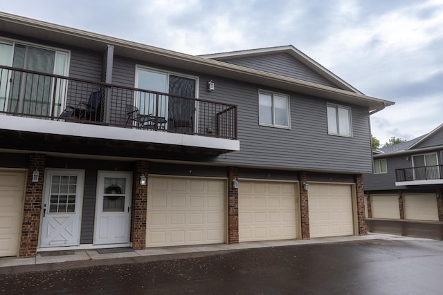 2041 Park Dr Unit 20414, Saint Paul, MN 55119 - view of front of property featuring a balcony, brick siding, and an attached garage