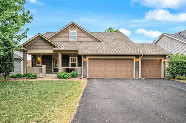 10025 Toledo Dr N, Brooklyn Park, MN 55443 - view of front of home featuring driveway, an attached garage, a front yard, roof with shingles, and covered porch