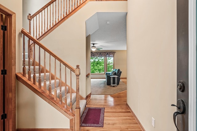 10025 Toledo Dr N, Brooklyn Park, MN 55443 - foyer with wood finished floors, ceiling fan, stairway, and baseboards
