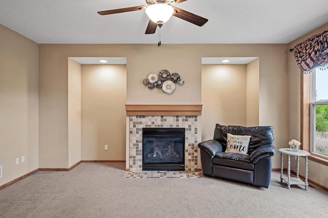 10025 Toledo Dr N, Brooklyn Park, MN 55443 - carpeted living room with ceiling fan, baseboards, and a tiled fireplace