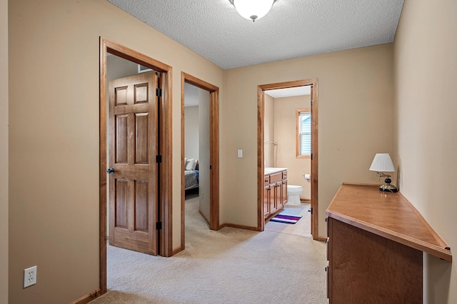 10025 Toledo Dr N, Brooklyn Park, MN 55443 - corridor with light colored carpet, a textured ceiling, and baseboards