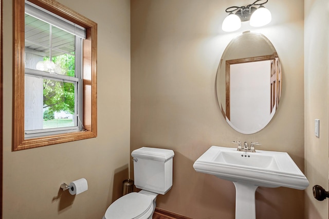 10025 Toledo Dr N, Brooklyn Park, MN 55443 - bathroom featuring toilet, baseboards, and a sink
