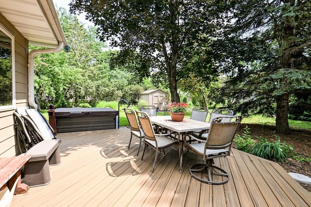 3760 Trenton Ln N, Plymouth, MN 55441 - wooden deck with a storage shed, outdoor dining space, a hot tub, and view of wooded area