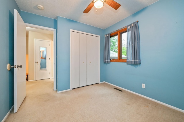 3760 Trenton Ln N, Plymouth, MN 55441 - unfurnished bedroom with carpet flooring, a closet, a textured ceiling, and a ceiling fan