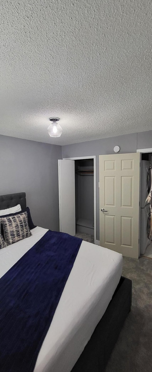 carpeted bedroom with a closet and a textured ceiling