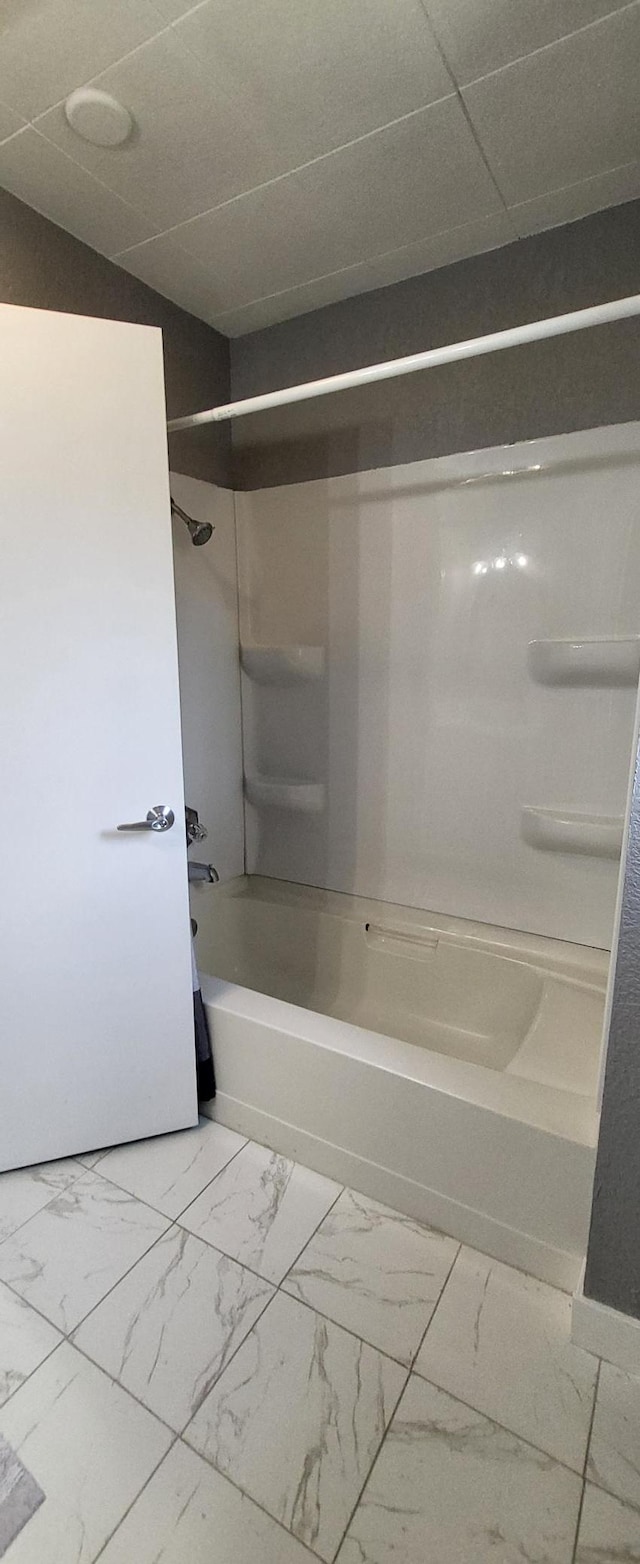 full bathroom with marble finish floors and tub / shower combination