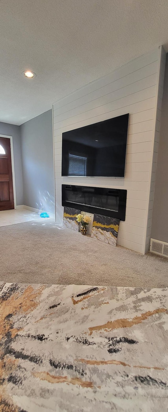 5252 Queen Ave N, Minneapolis, MN 55430 - detailed view of a glass covered fireplace, a textured ceiling, carpet flooring, wooden walls, and recessed lighting