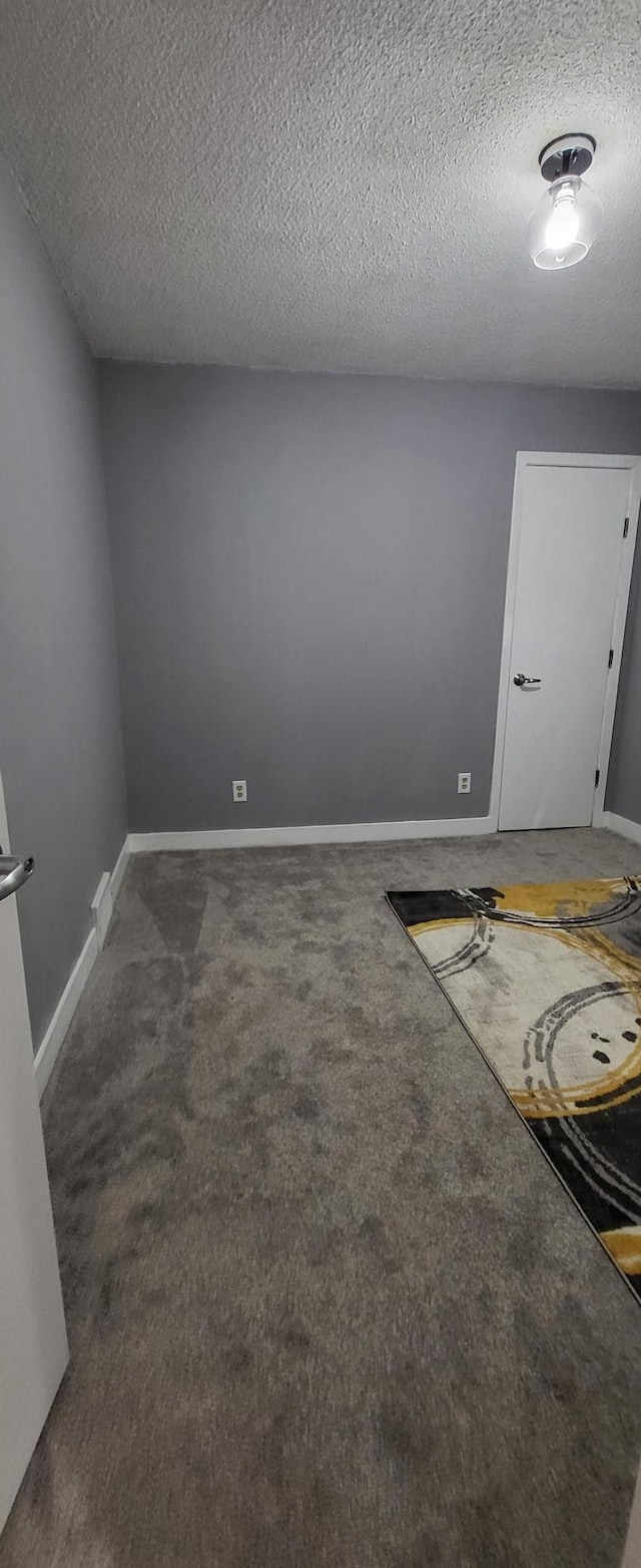 5252 Queen Ave N, Minneapolis, MN 55430 - spare room featuring dark colored carpet and a textured ceiling