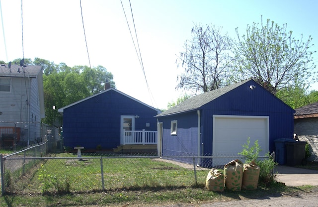 5252 Queen Ave N, Minneapolis, MN 55430 - view of front of home featuring an outdoor structure, a detached garage, and concrete driveway