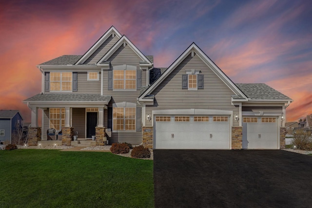 11632 Riverstone Trl, Woodbury, MN 55129 - craftsman house with asphalt driveway, a porch, a lawn, stone siding, and a garage