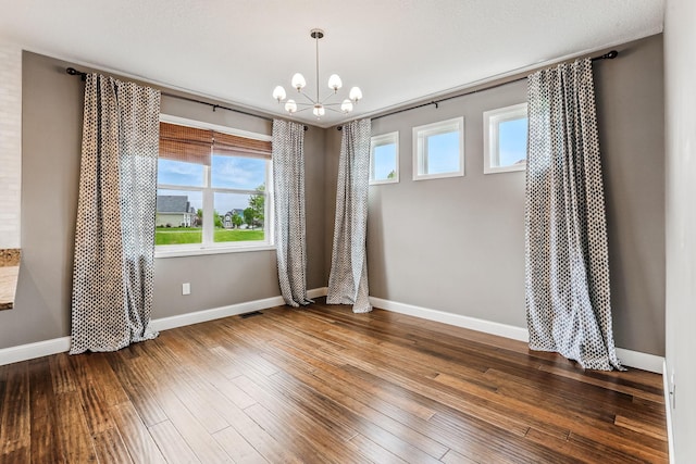 11632 Riverstone Trl, Woodbury, MN 55129 - spare room with a chandelier, hardwood / wood-style floors, and baseboards