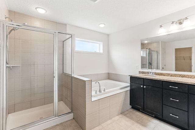 11632 Riverstone Trl, Woodbury, MN 55129 - bathroom with a shower stall, a garden tub, vanity, a spacious closet, and tile patterned floors