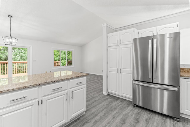 500 Ridge Ln, Chaska, MN 55318 - kitchen with freestanding refrigerator, vaulted ceiling, a chandelier, light wood-style flooring, and white cabinetry