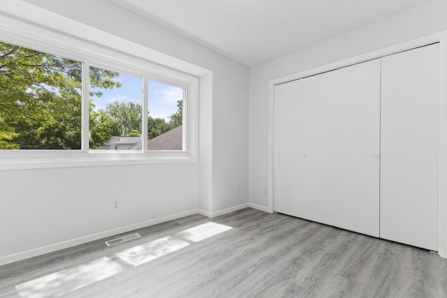 500 Ridge Ln, Chaska, MN 55318 - unfurnished bedroom featuring wood finished floors, baseboards, and a closet
