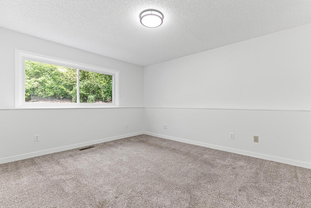 500 Ridge Ln, Chaska, MN 55318 - spare room with a textured ceiling, carpet flooring, and baseboards