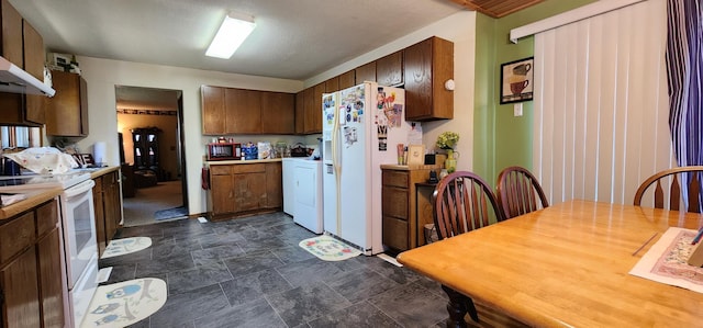 503 5th St SE, Staples, MN 56479 - kitchen with white appliances, light countertops, stone finish flooring, and wall chimney exhaust hood