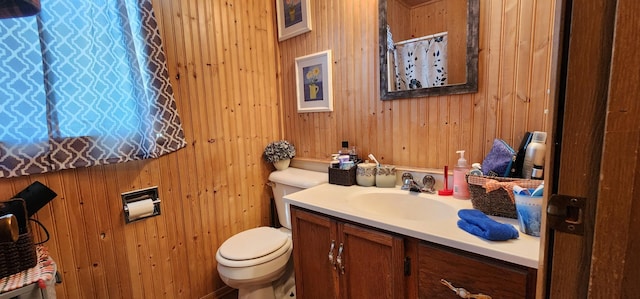 503 5th St SE, Staples, MN 56479 - full bathroom featuring toilet, vanity, wooden walls, and a shower with shower curtain