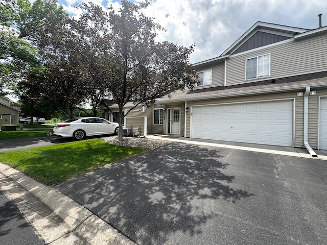 1784 Sandstone Curv, Shakopee, MN 55379 - view of front facade with asphalt driveway, an attached garage, and a front lawn