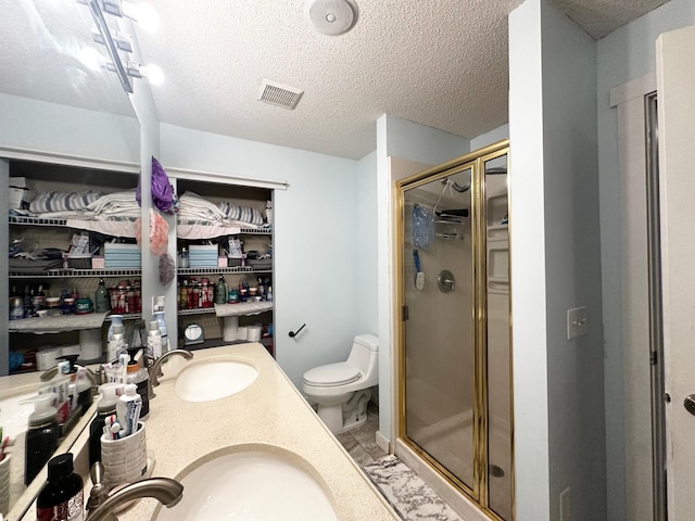 1784 Sandstone Curv, Shakopee, MN 55379 - bathroom featuring a shower stall, toilet, a textured ceiling, and double vanity