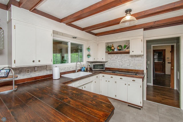 1513 40th Ave N, Moorhead, MN 56560 - kitchen with a sink, cooktop, stainless steel microwave, open shelves, and beam ceiling