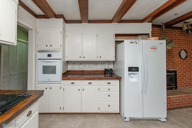 1513 40th Ave N, Moorhead, MN 56560 - kitchen with white appliances, beam ceiling, dark countertops, light tile patterned floors, and brick wall