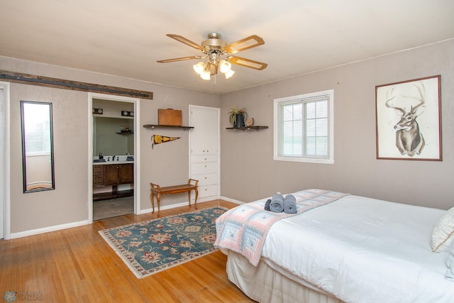 1513 40th Ave N, Moorhead, MN 56560 - bedroom with wood finished floors, baseboards, and a ceiling fan