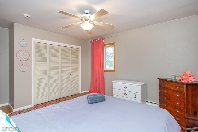 1513 40th Ave N, Moorhead, MN 56560 - bedroom with baseboard heating, a closet, baseboards, and ceiling fan
