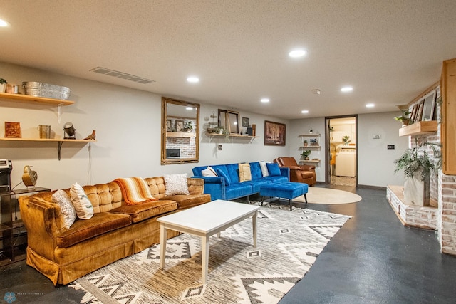 1513 40th Ave N, Moorhead, MN 56560 - living room with washer / dryer, recessed lighting, a textured ceiling, and concrete flooring