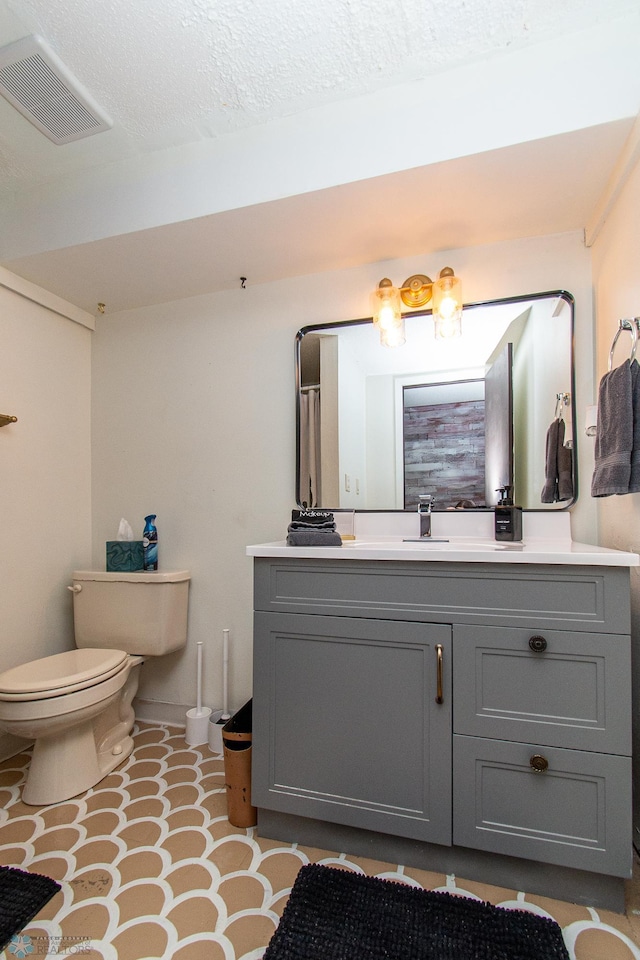 1513 40th Ave N, Moorhead, MN 56560 - bathroom featuring toilet, vanity, and a textured ceiling