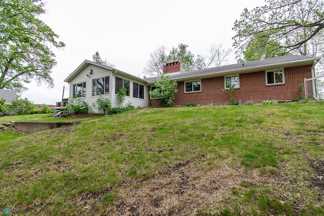 1513 40th Ave N, Moorhead, MN 56560 - back of house with a chimney, brick siding, and a yard