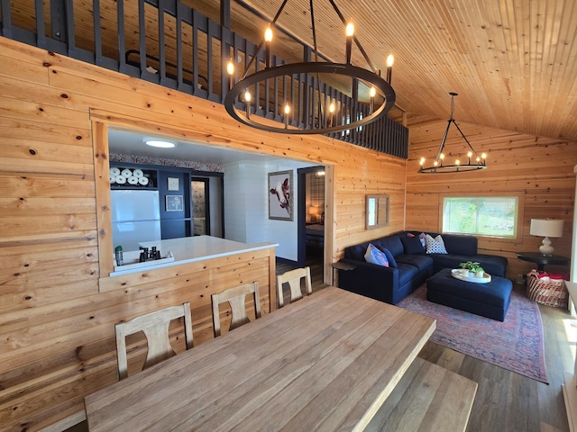 8137 Hoyt Ave SW, Victor Twp, MN 55349 - dining space with wood finished floors, a chandelier, wood walls, lofted ceiling, and wood ceiling