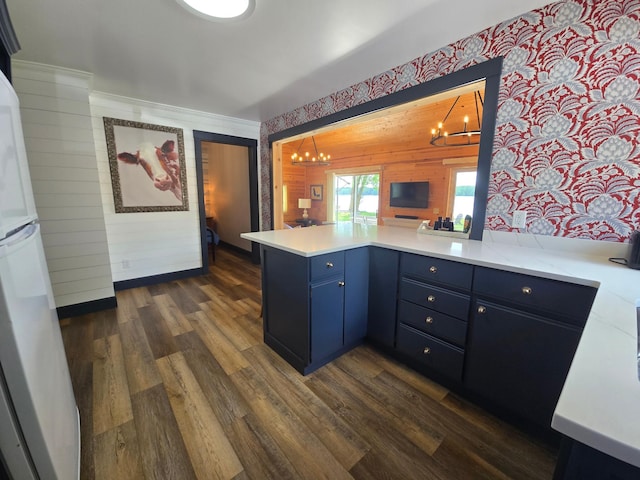 8137 Hoyt Ave SW, Victor Twp, MN 55349 - kitchen with a chandelier, blue cabinetry, a peninsula, light countertops, and dark wood finished floors
