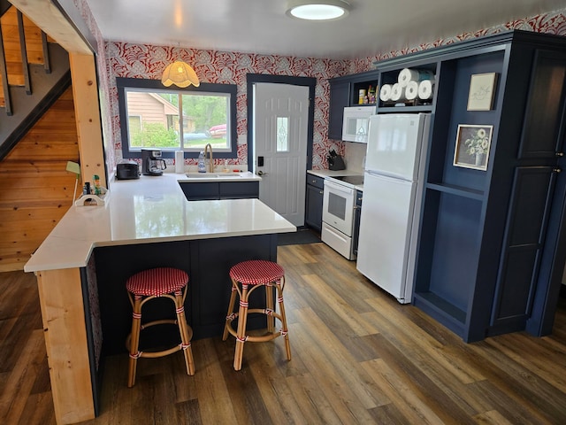 8137 Hoyt Ave SW, Victor Twp, MN 55349 - kitchen with white appliances, a sink, open shelves, a peninsula, and a kitchen breakfast bar