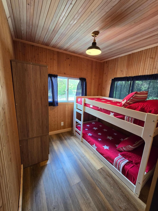 8137 Hoyt Ave SW, Victor Twp, MN 55349 - bedroom with wood finished floors, wooden ceiling, baseboards, and wood walls