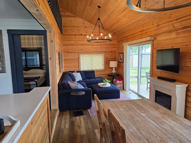 8137 Hoyt Ave SW, Victor Twp, MN 55349 - living area with vaulted ceiling, a fireplace, wood finished floors, wooden walls, and a chandelier