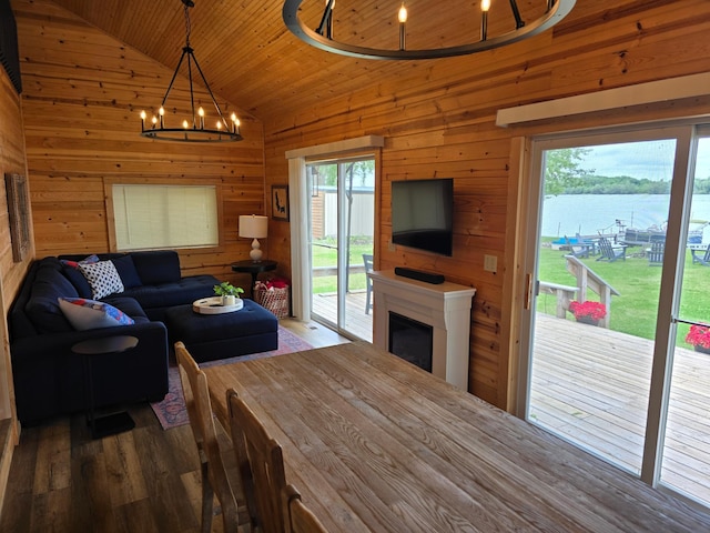 8137 Hoyt Ave SW, Victor Twp, MN 55349 - living area with wood walls, a chandelier, vaulted ceiling, wood finished floors, and wood ceiling