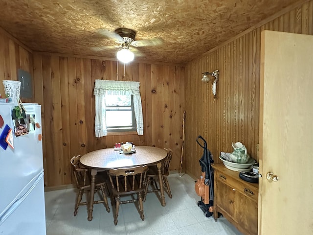 1529 Riddell Rd, Field Twp, MN 55723 - dining area featuring a ceiling fan, wood walls, and light floors
