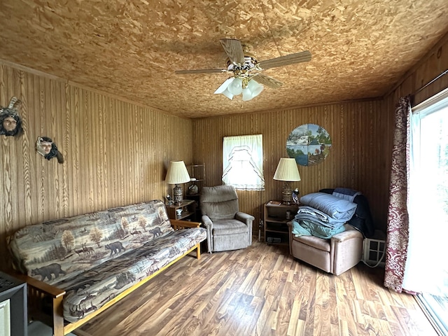 1529 Riddell Rd, Field Twp, MN 55723 - living area featuring ceiling fan, wood finished floors, and wooden walls