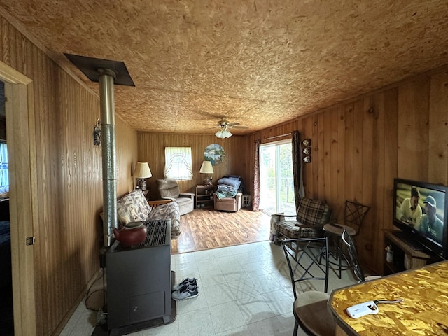 1529 Riddell Rd, Field Twp, MN 55723 - living area featuring a ceiling fan, wooden walls, and tile patterned floors