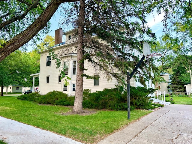 573 Rowland St, Tracy, MN 56175 - view of home's exterior with a chimney and a yard