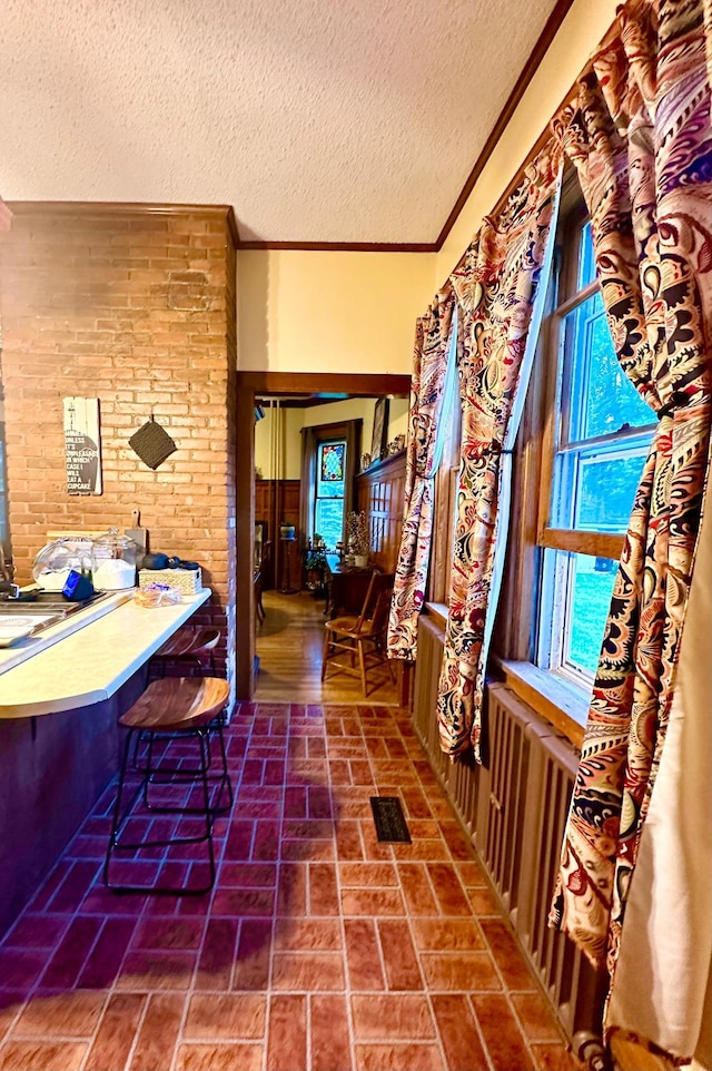 573 Rowland St, Tracy, MN 56175 - hall with a textured ceiling, brick patterned floors, and crown molding