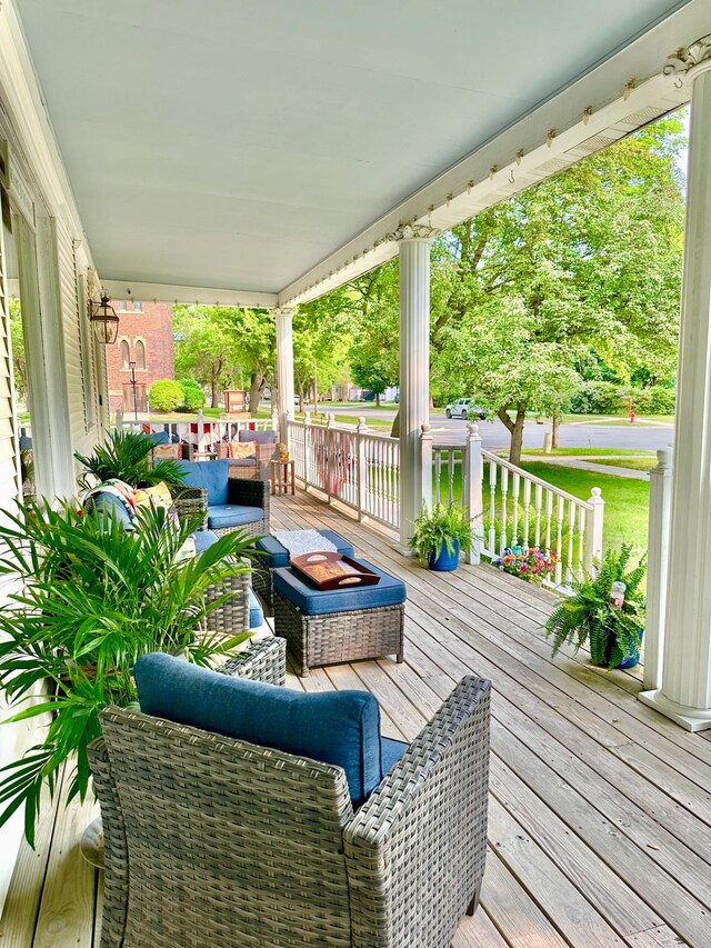 573 Rowland St, Tracy, MN 56175 - wooden porch featuring an outdoor living space